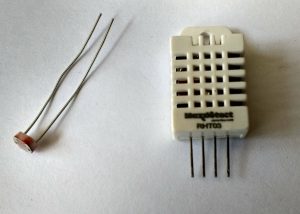 Fig. 2 A light dependent resistor (left) and a DHT22 combined humidity and temperature sensor (right).
